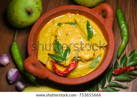 Kerala style King or Barracuda fish curry with coconut milk mild spicy seafood cuisine Kerala , India. Rice and fish is a popular delicious recipe in the Indian coastal area restaurant. 