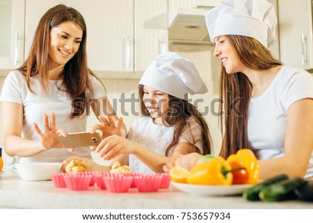 picture of young family take photo of food onsmart phone while cooking at kitchen