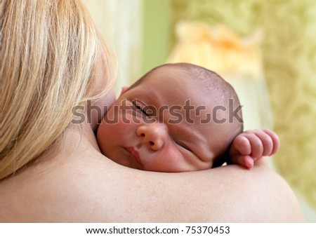 Newborn baby boy sleeping on mother's shoulder Royalty-Free Stock Photo #75370453