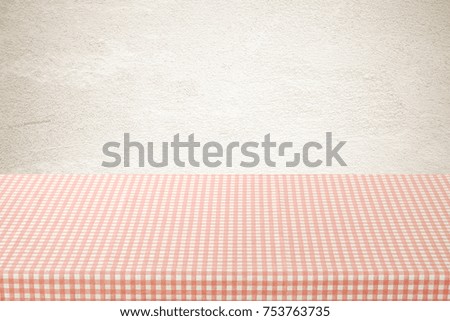 Empty table cover with pink and white tablecloth over brown cement wall background, banner, table top, counter design for food and product display montage