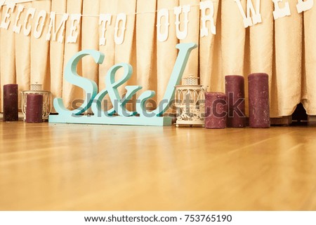 Wedding interior decoration. Wooden letters S and J to the table.