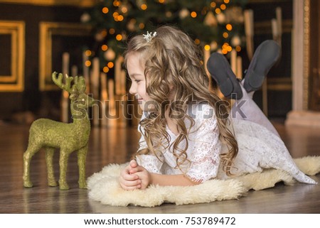 Lovely girl on the background of a Christmas tree