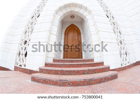old eastern style door in white building