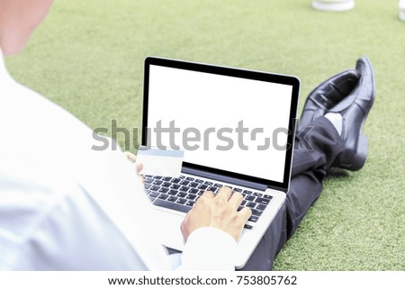 Businessman or student typing on keyboard laptop and holding credit card are shopping online. The blank screen with copy space for your text or advertising content. clipping path on picture.