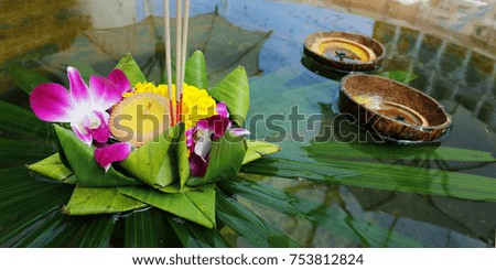  krathong ,hand crafted floating basket by banana leaf,decorated with flowers and incense sticks, candle,light and float on water to celebrate festival Loy Krathong