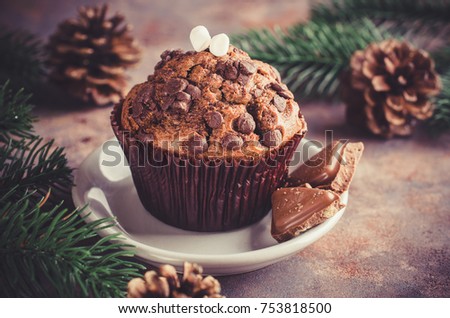 Chocolate muffin and branches fir. Christmas time. Selective Focus. Copy space. Vintage stile. Toned image