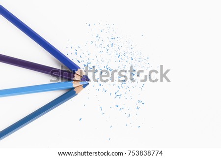 Combination of Blue color pencils with sharp tips along with shavings isolated on white background