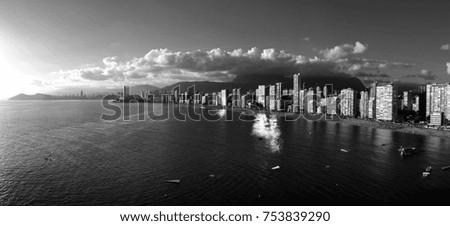 black and white photo of the city by the sea