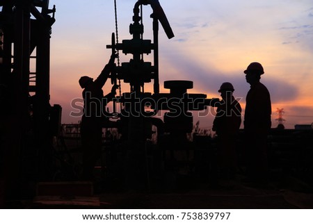 In the eveningï¼?oil field, the oil workers are working