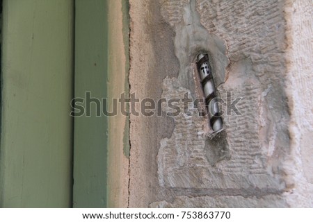 A "mezuzah", a decorative case containing a piece of parchment with a verse from the Hebrew bible, on the doorpost of a Jewish home in Jerusalem. Royalty-Free Stock Photo #753863770