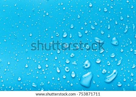 Drops of water on a color background. Blue. Toned.