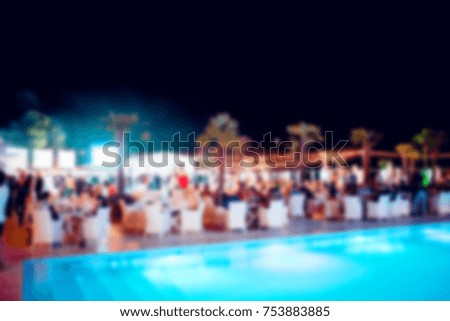 Blurred for background. Night club dj party people enjoy of music dancing sound with colorful light with Smoke Machine and lights show.
