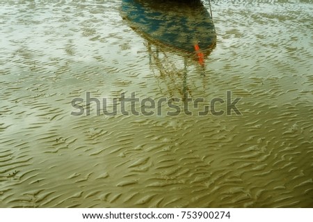 refection of fisherman boat on the beach
