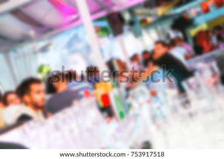 Blurred for background. People smiling and posing on cam during concert in night club party. Man and woman have fun at club. Boy and girl at night club party