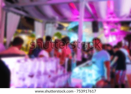 Blurred for background. People smiling and posing on cam during concert in night club party. Man and woman have fun at club. Boy and girl at night club party