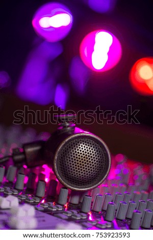 Vintage Microphone and Headphones on dirty sound mixer panel, France