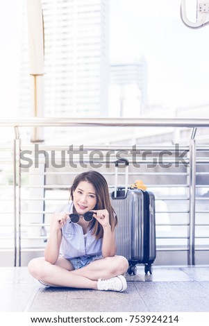 beautiful happiness young asian girl in casual dress traveling alone at train station or airport with backpack vintage tone photo concept