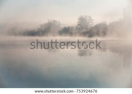 Morning on the river early morning reeds mist fog and water surface on the river Royalty-Free Stock Photo #753924676