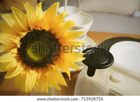Background of Yellow Artificial Sunflower Flowers The Kitchen Table for Home and Building Decoration.