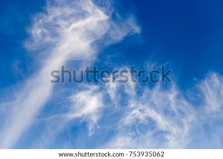 white clouds against blue sky as background .