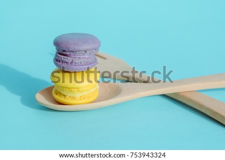 Sweet and colourful french macaroons or macaron on pastel blue background, Dessert.