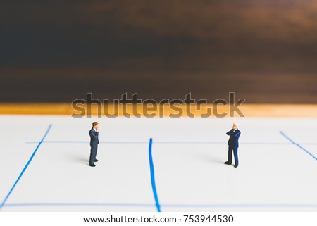 Miniature Businessman standing on arrow pathway , Business decision concept.