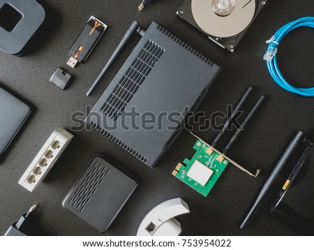 top view of Computer Network Devices concept with Hub, Switch, Router, Modem, wireless card on black table background with copy space.