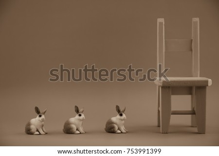rabbits.chair.in line.wooden chair.miniature rabbits.miniature toys.