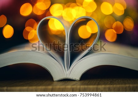 Book page decorate to heart shape with celebration bokeh light for love and romance of valentines day concept