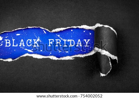 The Torn black Paper and BLACK FRIDAY word with sky blue paper background , black friday shoping concept