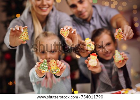 Picture showing happy family preparing Christmas biscuits