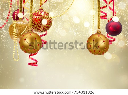Golden and red christmas balls garland and evergreen fir tree on glowing golden background