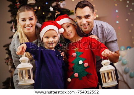 Picture showing happy family posing with Christmas lanterns