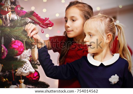 Picture showing children decorating Christmas tree