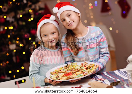 Picture showing joyful kids preparing Christmas biscuits