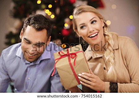 Picture Showing Happy Couple Opening Christmas Present