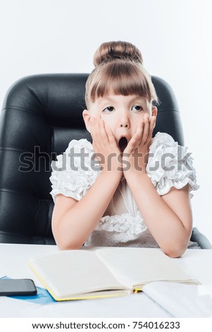 beautiful business girl sitting on a chair and in shock