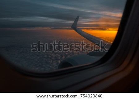 Wing of an airplane in the morning sunrise. Photo taken in the sky. Picture for add text message or frame website..