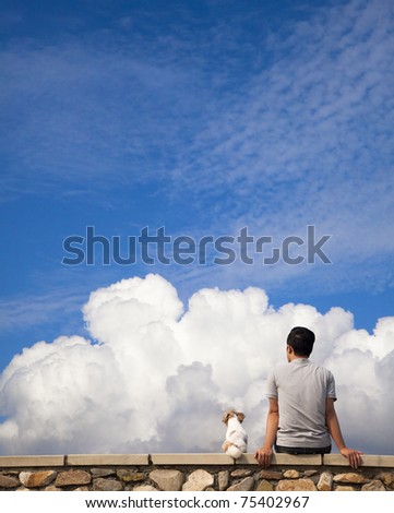 Man sitting with  dog and watching the cloud of summer Royalty-Free Stock Photo #75402967