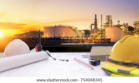 Working table engineer with tablet and tools in oil refinery industry business plant. Royalty-Free Stock Photo #754048345