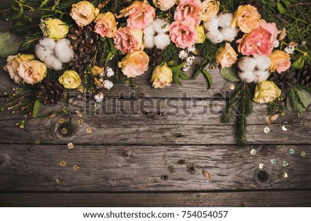 New Year composition of flowers, gifts, dried fruits on a wooden table. Christmas background. top view