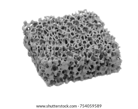 Spongy ceramic filter for molten metal. Filtering element for metallurgy. Isolated on white background. Royalty-Free Stock Photo #754059589