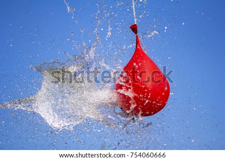 Explosion of balloon full of water on sky background
