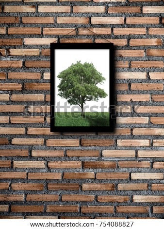Photo of tree in photo frame on brick wall. Only place you can see a tree is a picture hanging on a brick wall. Environment and Nature concept.