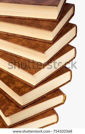 A stack of old brown books on a white background