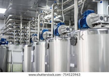A number of steel tanks for mixing liquids. Stainless steel, food industry. Royalty-Free Stock Photo #754123963