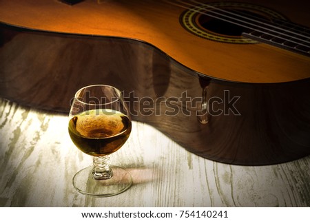 Concept behind the music the guitar, the glass of cognac 