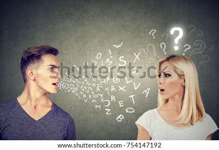 Language barrier concept. Handsome man talking to an attractive young woman with question mark  Royalty-Free Stock Photo #754147192