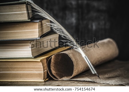 Old quill pen with old paper scroll and books on the table. Letter writing. Historical atmosphere.  Royalty-Free Stock Photo #754154674
