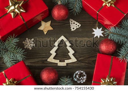 christmas gifts with decorations on wooden background